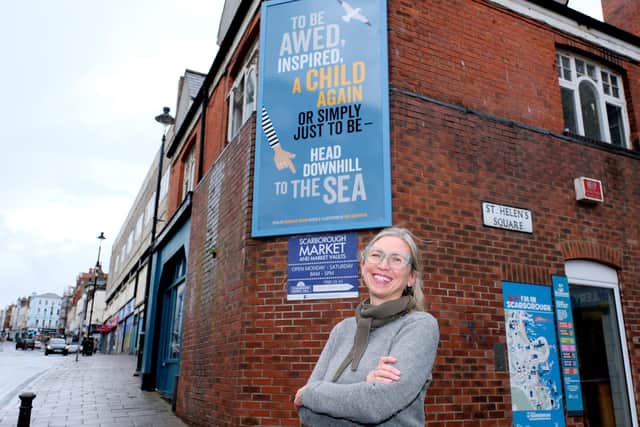 Poet Charlotte Oliver with her poem written for the mural at the corner of Eastborough and St Helens Square in Scarborough
