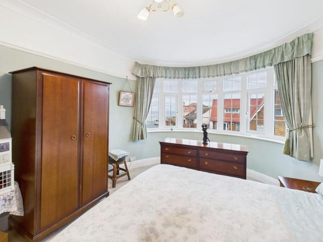 A bay-fronted bedroom has views out to sea.
