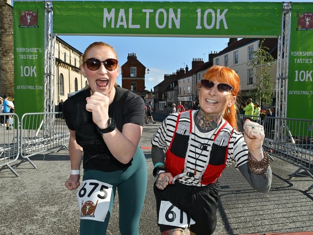 Runners celebrating crossing the finish line. photo: Richard Ponter