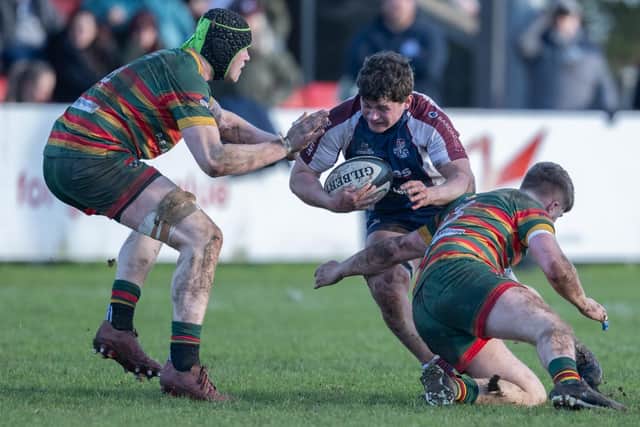 Ted Barker tries to evade two Selby tacklers. Photo by Andy Standing