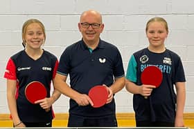 England player Phoebe O'Brien, left, with her Premier Club Piranhas teammates Lester Smith and Roslyn Payne. Photo by Karl Cousins