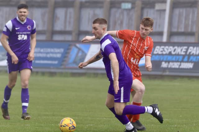 A Spa player pushes on against Springhead.