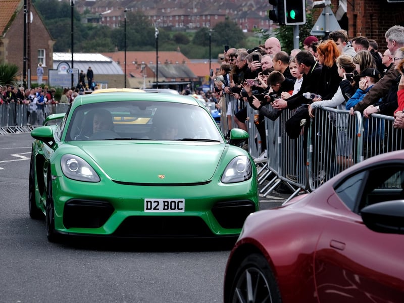 Spectators line Langborne Road to watch the cars parade.
picture: Richard Ponter