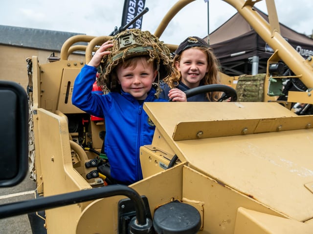 Alifie, 4, with his sister Skyler Jeavons, 10, of Leeds, in the driving seat of a Jackal 1 (4x4 Patrol Vehicle).