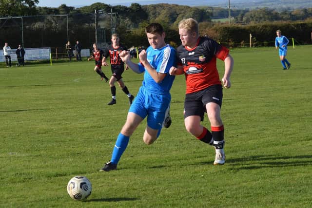 Heslerton Under 16, in blue, in action against North Duffield Dragons.