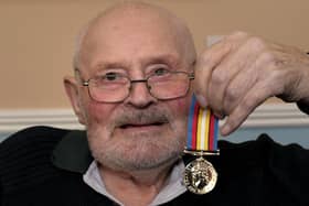 Eric Copeland pictured with his Nuclear Test medal.
