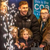 The Christmas lights switch-on in Whitby with Judith Aconley, 5 and Whitby Town skipper Dan Rowe.
picture: Brian Murfield.