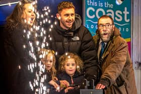 The Christmas lights switch-on in Whitby with Judith Aconley, 5 and Whitby Town skipper Dan Rowe.
picture: Brian Murfield.