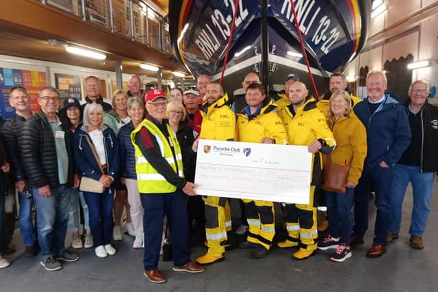 A cheque for £1,600 was handed to the lifeboat crew following the recent Porsches on the Prom event. Photo: Bridlington RNLI