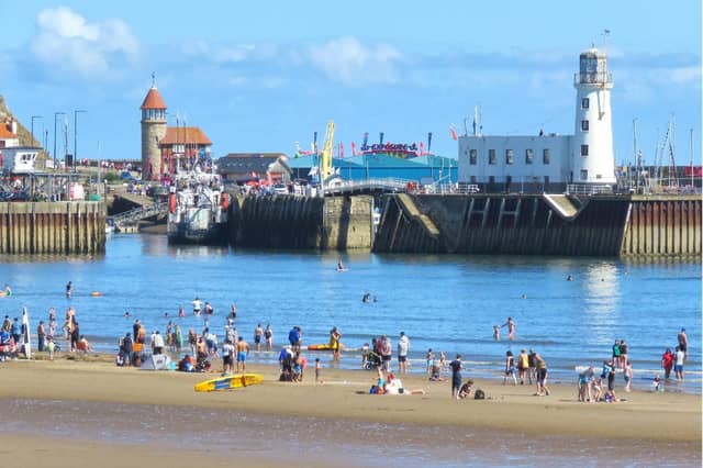 Paddling near the harbour entrance and lighthouse, captured by Tony Freeman.