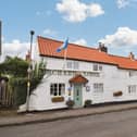The front aspect of Orchard Lodge, in its attractive village setting.