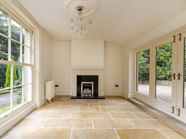 A full height sash window opens up this room, with Jerusalem stone flooring, a gas fire with granite hearth and French double doors.