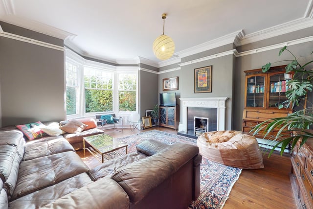 A large and well lit sitting room again has a focal fireplace, and stunning bay window.