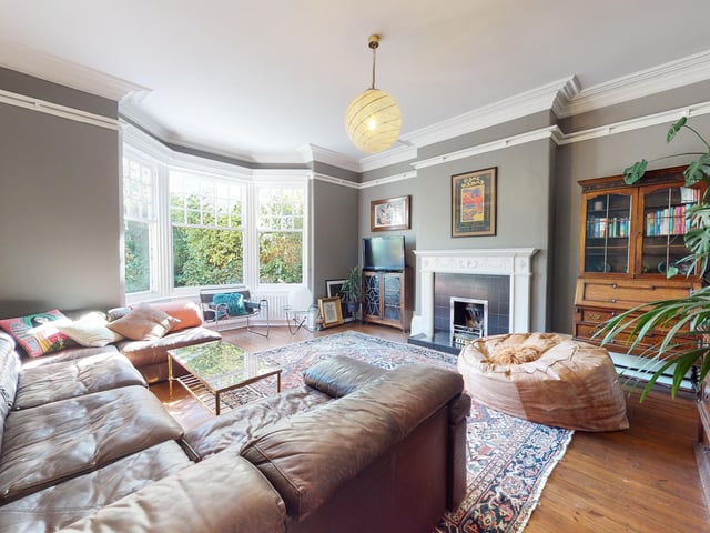A large and well lit sitting room again has a focal fireplace, and stunning bay window.
