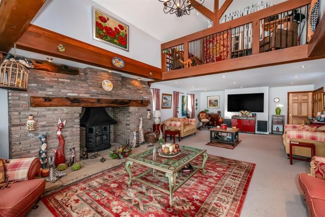A stunning stone fireplace in this reception room with gallery landing.