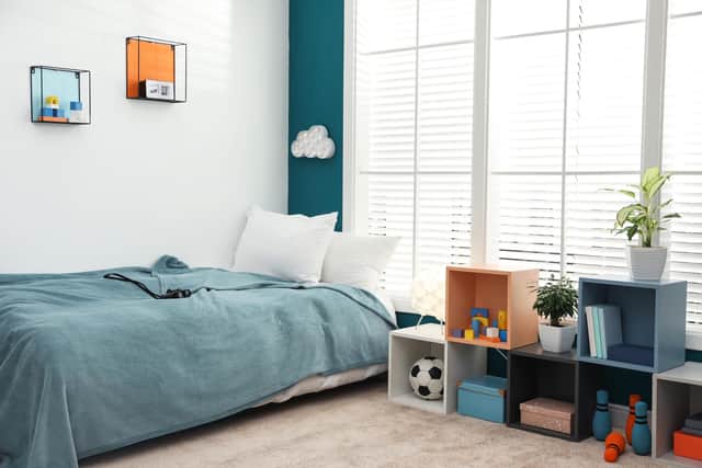 Easy box storage in this bedroom with the bed near the window.