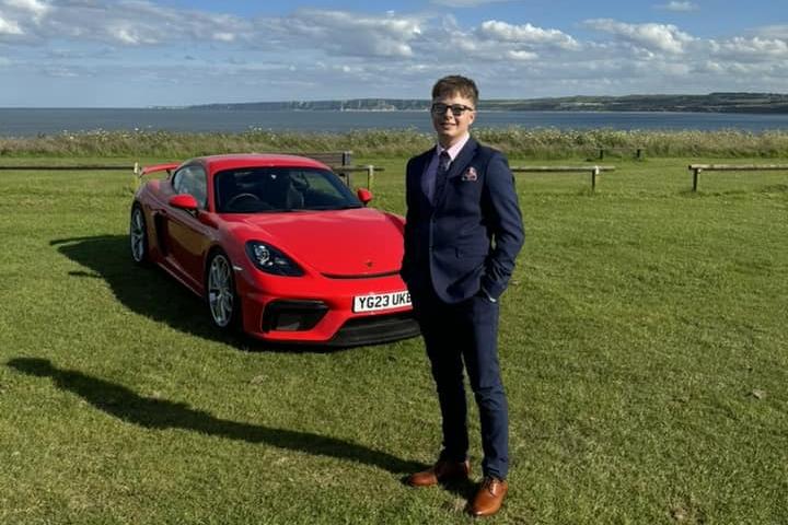 Looking dapper next to a gorgeous car.