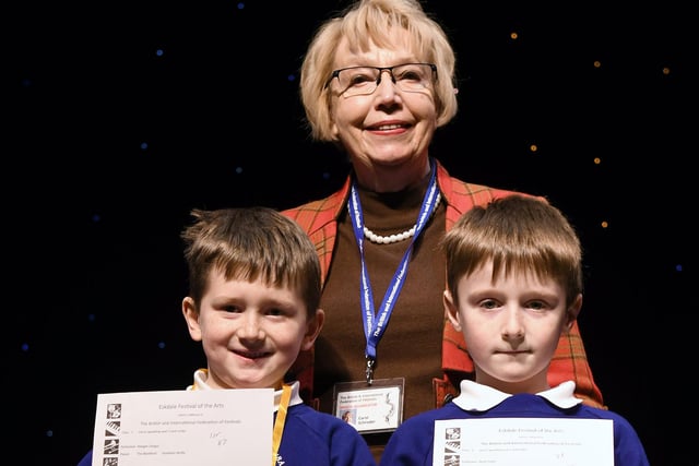 Carol Schroder presents youngsters with their certificates at the Eskdale Festival of the Arts.