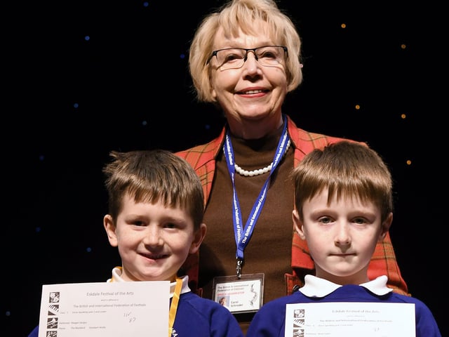 Carol Schroder presents youngsters with their certificates at the Eskdale Festival of the Arts.