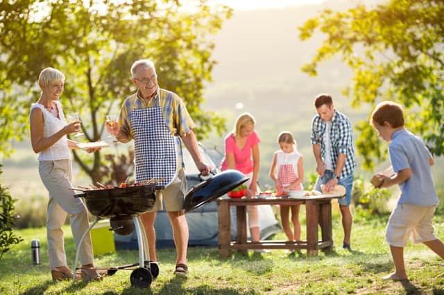 Happy family enjoying a barbecue on a hot summer's day