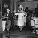 1st December 1959:  Piping in the haggis in the restaurant at the Savoy Hotel, London.The haggis born by a chef is preceded by a piper and the whisky.  It is usually eaten on Burns night (25th January).  (Photo by Evening Standard/Getty Images)