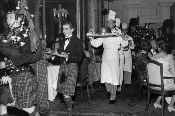 1st December 1959:  Piping in the haggis in the restaurant at the Savoy Hotel, London.The haggis born by a chef is preceded by a piper and the whisky.  It is usually eaten on Burns night (25th January).  (Photo by Evening Standard/Getty Images)