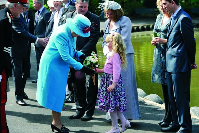 The Queen is presented with a bouquet by six-year-old Sophie Bellringer, from Hull, who was chosen from a draw of Yorkshire Water employees families, to present a posy to the Queen, on her arrival.
102086c