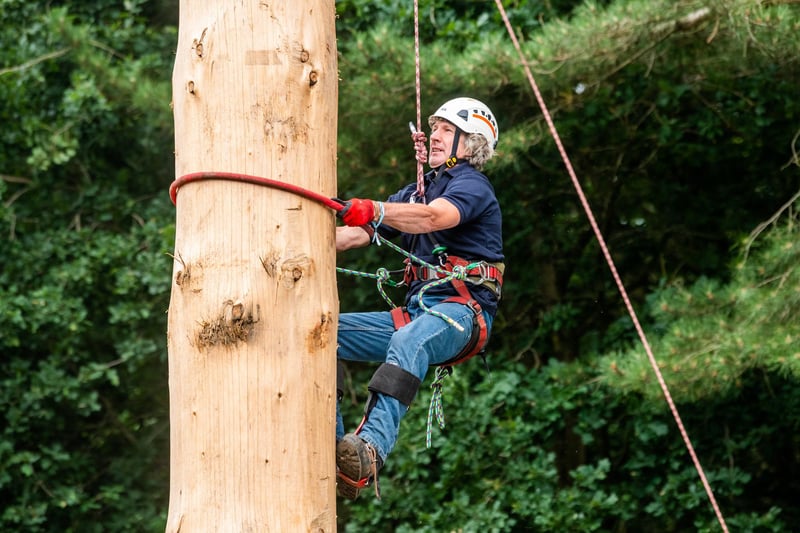 Andy Kirkwood (aged 61) taking part in the Pole Climbing Championships on the second day of the show