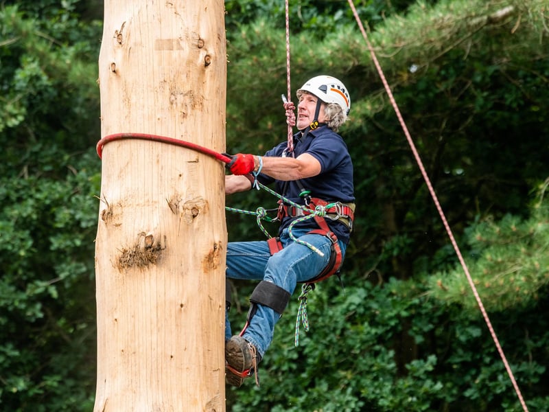Andy Kirkwood (aged 61) taking part in the Pole Climbing Championships on the second day of the show