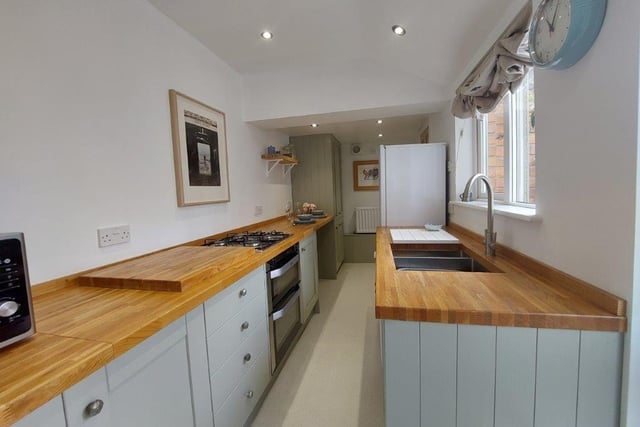 Within the bright and modern kitchen with wooden worktops is an integrated electric oven and gas hob.