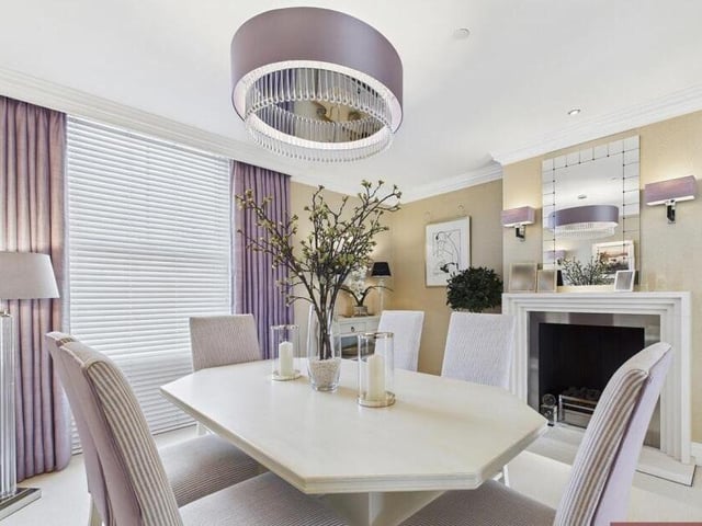 A modern, stylish dining room with fireplace.