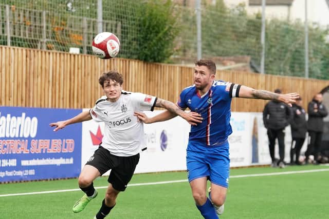 Whitby Town skipper Dan Rowe battles for the ball during the 2-0 loss at Marine on Saturday in the NPL Premier Division PHOTO BY KARL DUNKERLEY