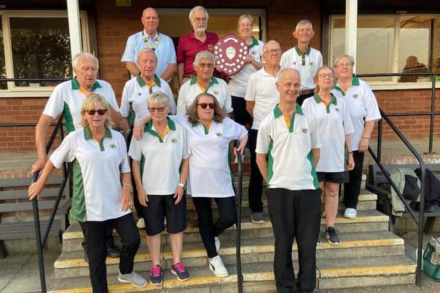 East Coast President Emmo Emmerson and shield sponsor David Muir presents Borough captain Jo Gates with the shield, while the Borough team line up.