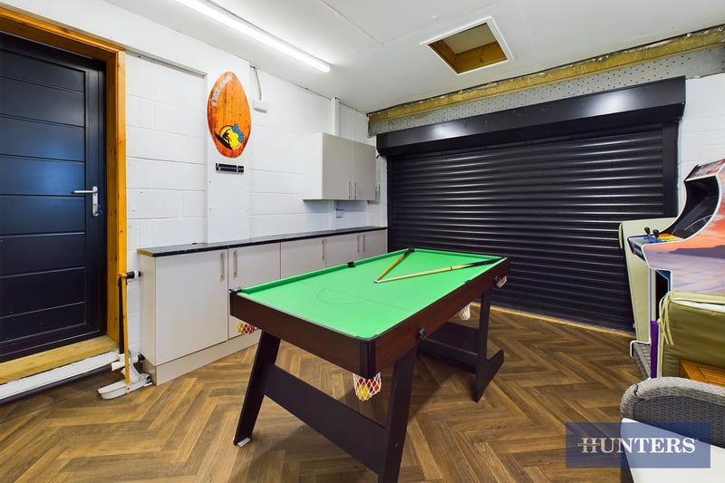 The converted garage is currently used as a games room and utility room.