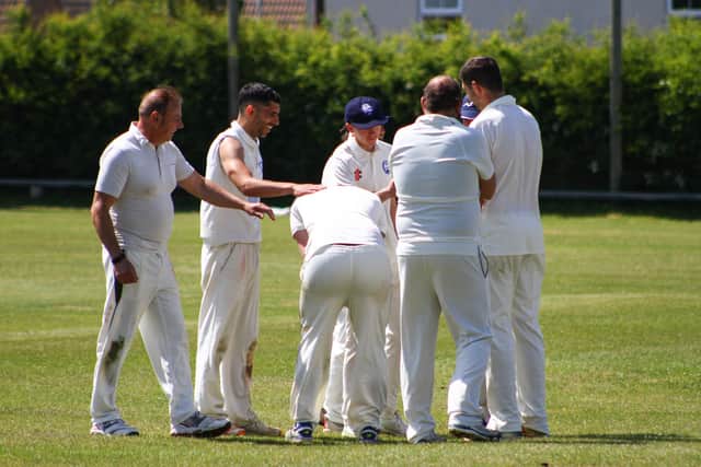 Visitors Flamborough celebrate a breakthrough at Cayton 2nds.