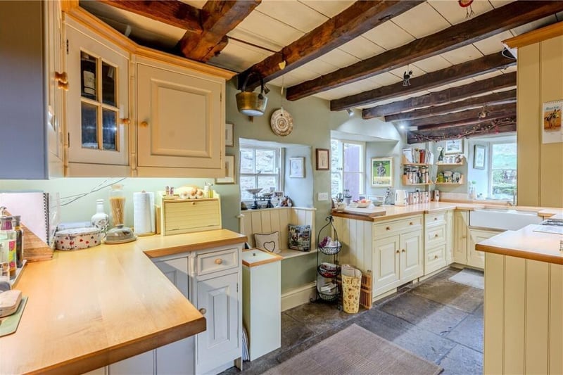 A bright country style kitchen with window seat feature.