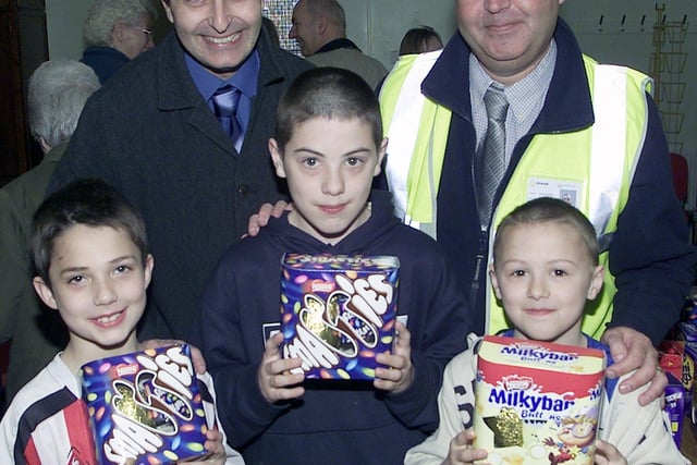 Sheffield Homes Area Manager Simon Young and Dave Moxon, Keepmoat's Senior Site Manager with three of the kids that received the Easter eggs in 2006