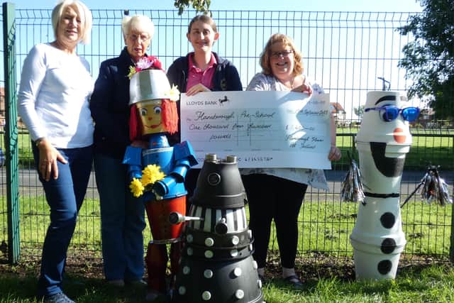 Here are some of the Flamborough Flower Pot Festival organisers handing over a cheque to the Pre-School.