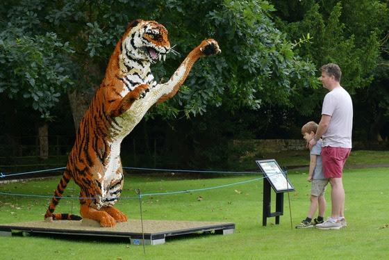 This tiger who is stood on its hind legs towers over all of the visitors to the exhibition.