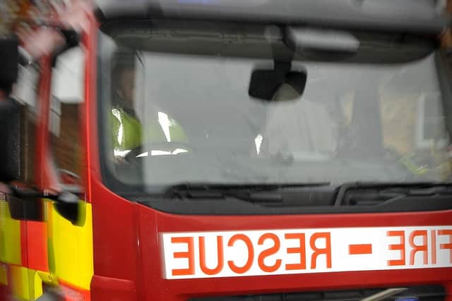 Fire crews were called to assist a woman who had become trapped underneath her own vehicle