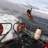 Snapshot taken from the video showing the Coastguard team member making his way to the Bridlington RNLI lifeboat. Photo courtesy of RNLI/Mike Milner.