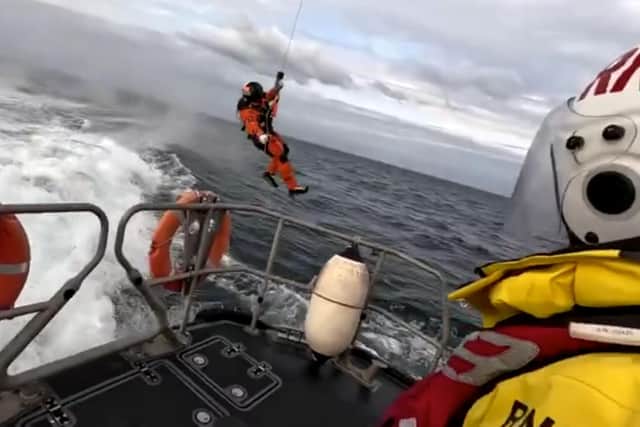 Snapshot taken from the video showing the Coastguard team member making his way to the Bridlington RNLI lifeboat. Photo courtesy of RNLI/Mike Milner.