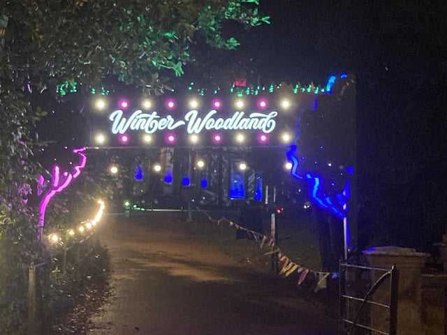 The beautiful sign marks the start of the upcoming trail, with twinkling lights showing visitors the way.