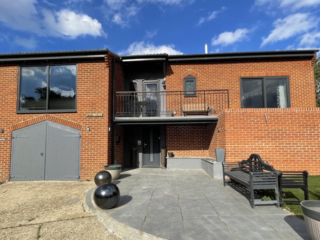A driveway leads up to the four to five bedroom house.