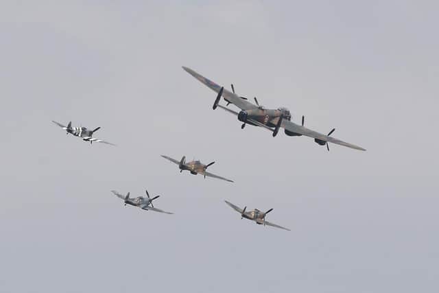 Three Spitfires, a Hurricane and a Lancaster bomber in flight. (Pic credit: Peter Byrne / Getty Images)