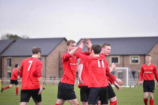 Tom Scrowston is congratulated for putting Pocklington Town ahead in their 1-1 draw at home to title rivals Hedon Rangers.