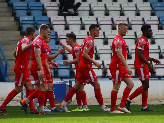 The Athletic players celebrate their goal.
