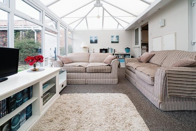 The large conservatory has versatile space and views of the garden and beyond.