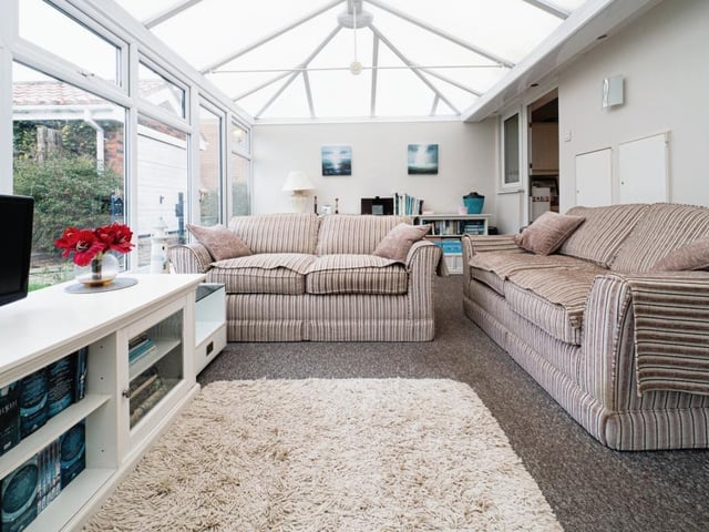 The large conservatory has versatile space and views of the garden and beyond.