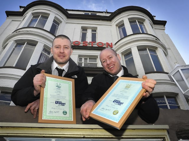 Pictured are the managers of the family run Boston Hotel on Queen's Parade with the two awards for the hotel from coach holiday company, David Urquhart Travel, voted for by their customers.